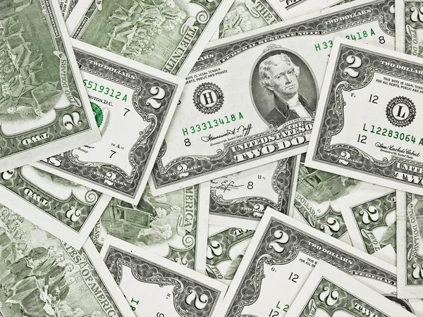 Uma pilha de dois dólares contas como um fundo de dinheiro — Fotografia de Stock