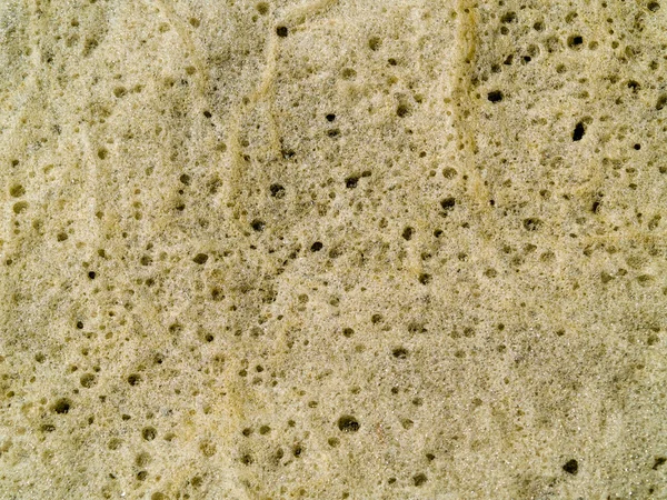 Seafoam Textura fundo à esquerda na praia por Ondas — Fotografia de Stock