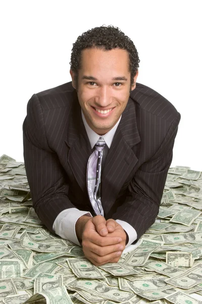 Business man lying on money — Stock Photo, Image