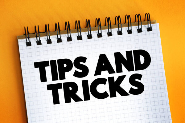 Tips And Tricks text on notepad, concept background