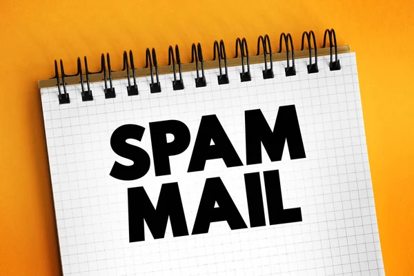 Spam mail - unsolicited and unwanted junk email sent out in bulk to an indiscriminate recipient list, text concept on notepad