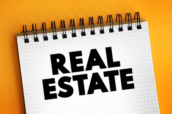 Real estate - form of real property, land along with any permanent improvements attached to the land, including water, trees, minerals, buildings, homes, fences, and bridges, text on notepad