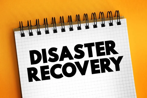 Disaster recovery - set of policies, tools, and procedures to enable the recovery of vital technology infrastructure following a natural disaster, text concept on notepad