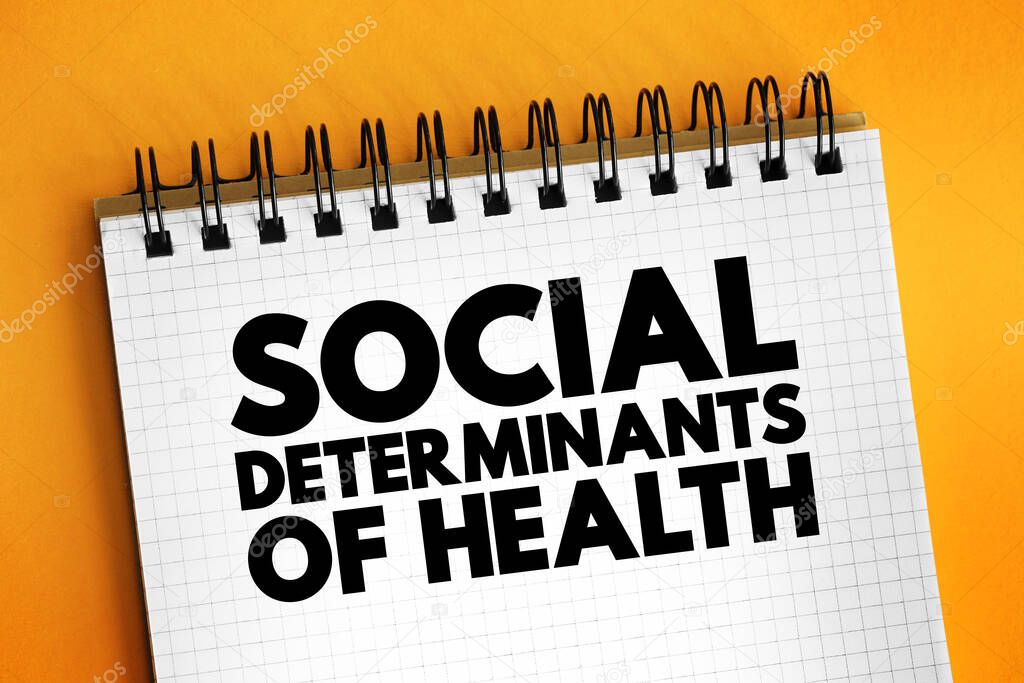 Social determinants of health - economic and social conditions that influence individual and group differences in health status, text concept on notepad