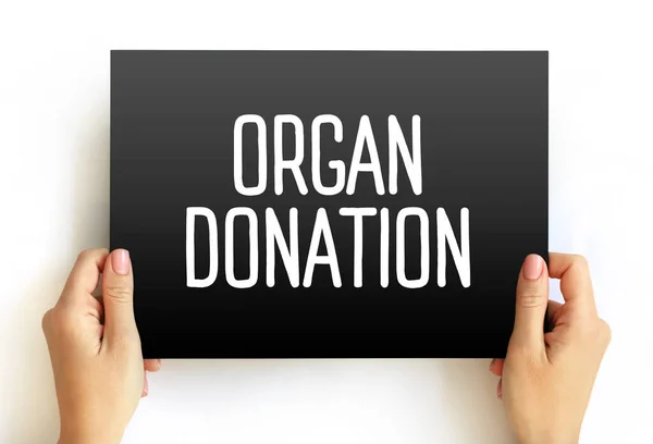 Organ Donation - process of surgically removing an organ or tissue from one person and placing it into another person, text concept on card