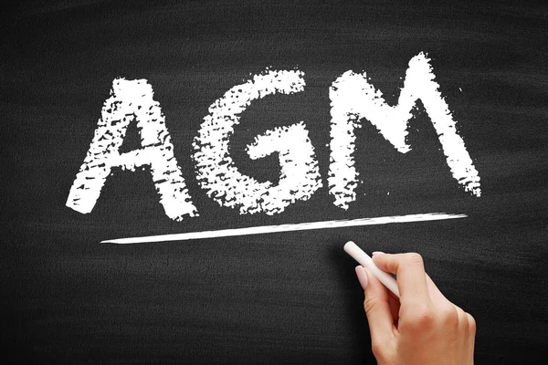 AGM - Annual General Meeting is a meeting of the general membership of an organization, acronym business concept on blackboard
