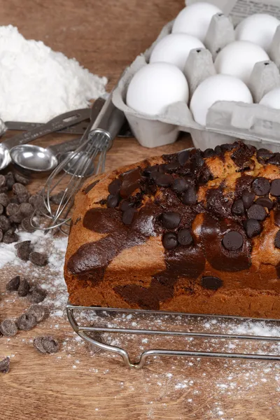 Chocolate chip pound cake with baking ingredients — Stock Photo, Image