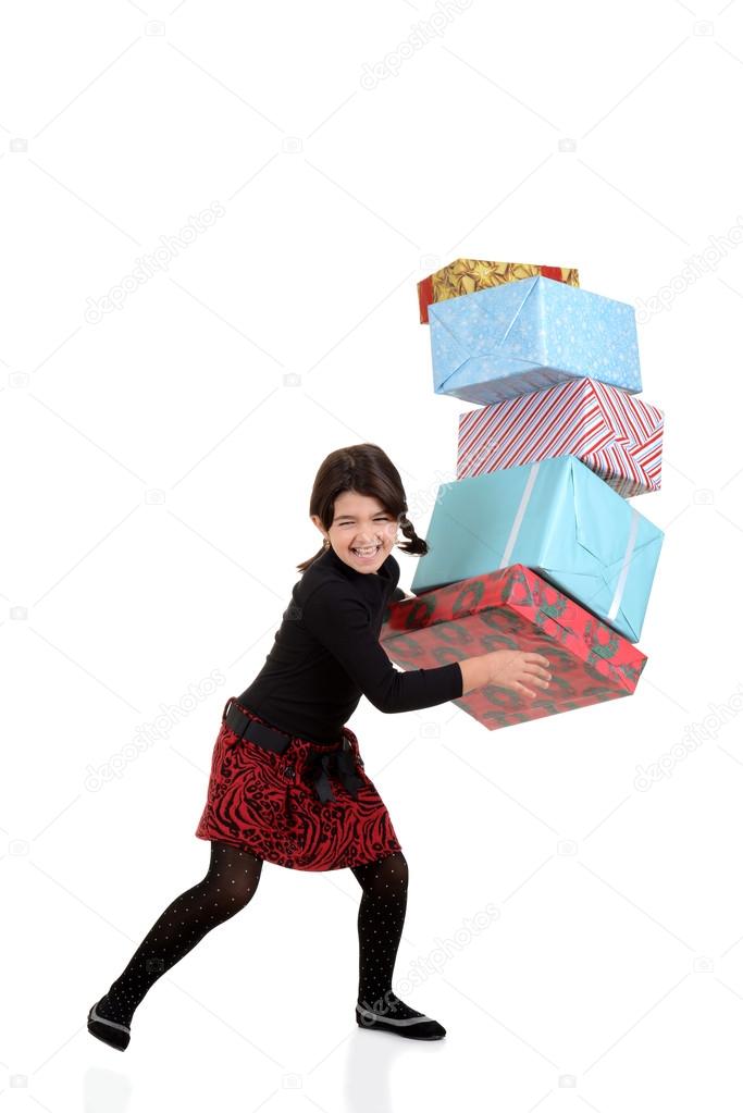 Young girl dropping pile of christmas gifts