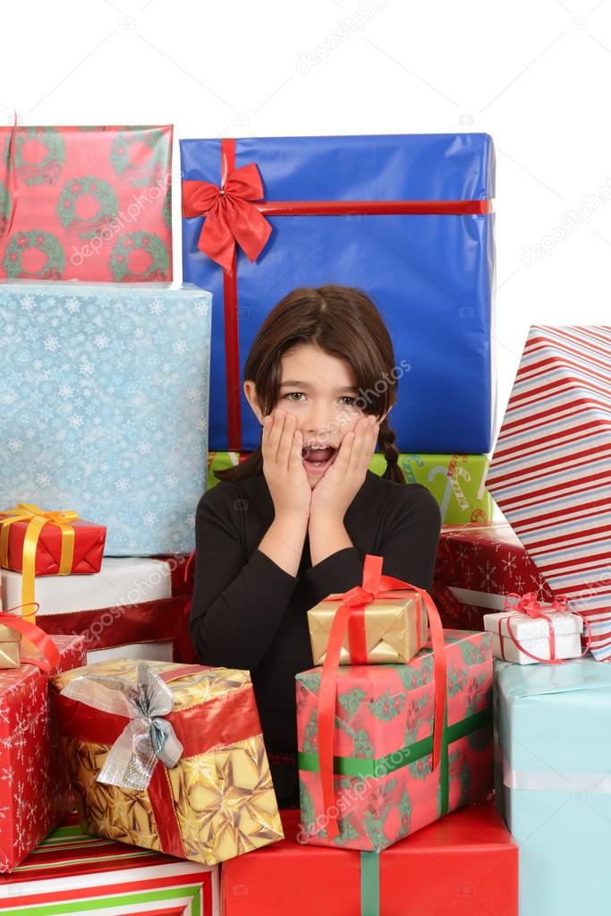 Child surprised with lots of christmas gifts