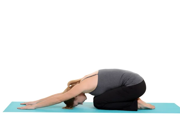 Woman doing yoga on blue mat — Stock Photo, Image