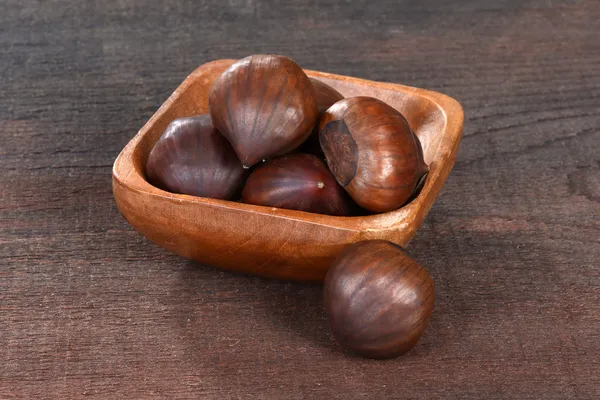 Chestnuts in a wood bowl — Stock Photo, Image