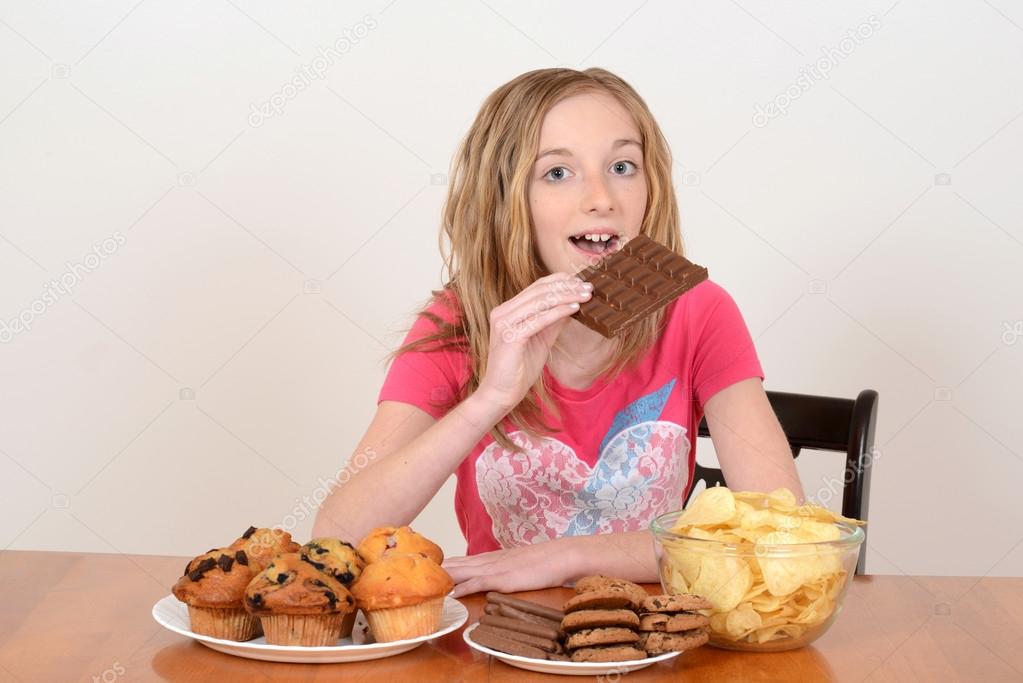 young child eating large chocolate bar