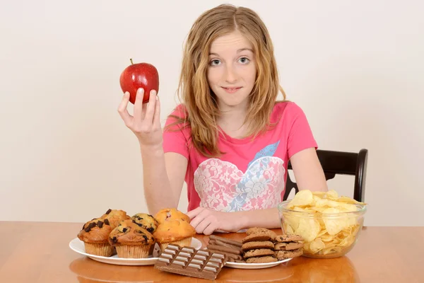 child with apple and junk food concept