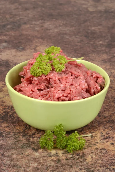 Ground beef in a green bowl — Stock Photo, Image
