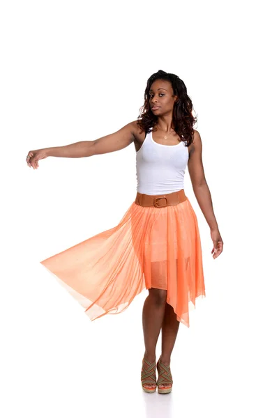 Playful black woman with orange skirt — Stock Photo, Image
