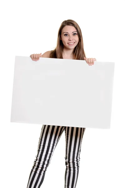 Chica adolescente con pantalones de rayas sosteniendo el cartel en blanco — Foto de Stock