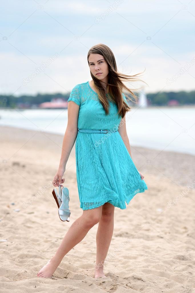 Teen girl on the beach with bare feet