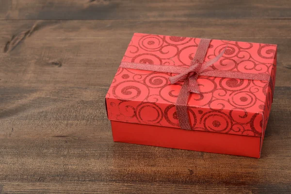 Red christmas present on wood — Stock Photo, Image