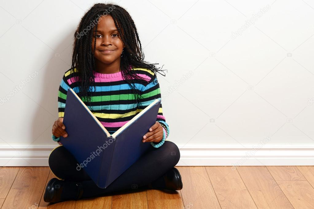 Happy child reading a book