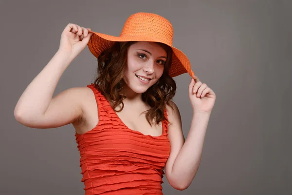 Teen girl hold orange straw hat — Stock Photo, Image