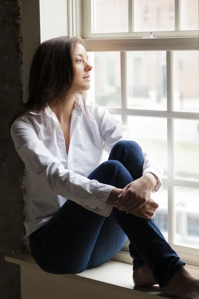 Woman by the window — Stock Photo, Image