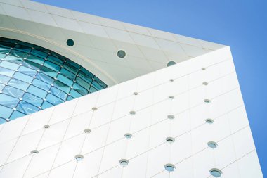 Architectural details of a modern building wiith blue skies in the background