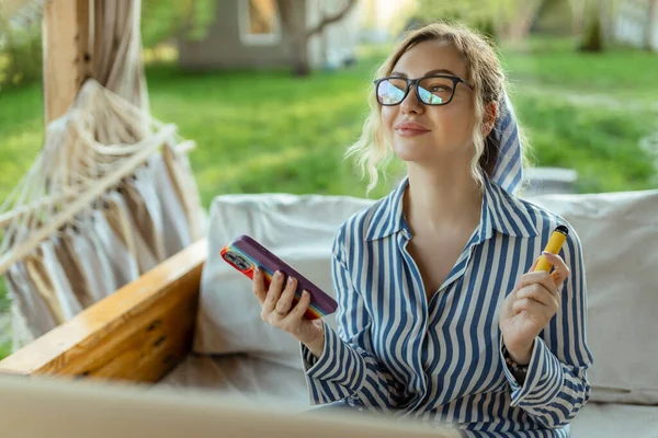 Ein Schönes Mädchen Raucht Eine Elektrodenzigarette Und Benutzt Ein Smartphone — Stockfoto