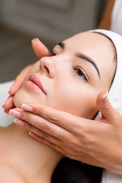 Professional anti-aging facial massage. Action. Relaxing facial treatment at Spa. Relaxing and rejuvenating facial massage for women.