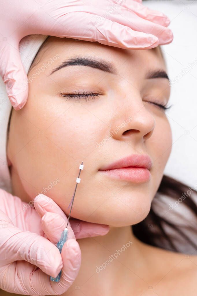 Face lifting PDO Suture operation. innovative technique of New thread lift, cosmetologist preparing to do procedure to female client, select the appropriate thread option. 