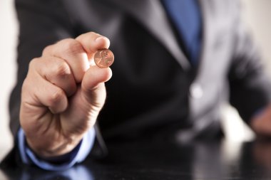 Businessman Holds Penny clipart