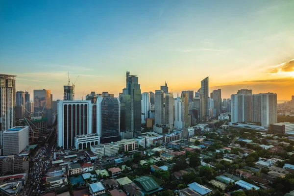 skyline of makati in metro manila, philippines at sunset