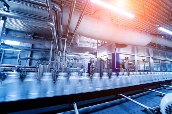 Conveyor belt with bottles of drinking water at a modern beverage plant.