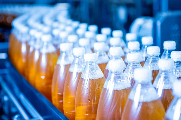 现代饮料工厂中装有果汁或水瓶子的输送带 — 图库照片