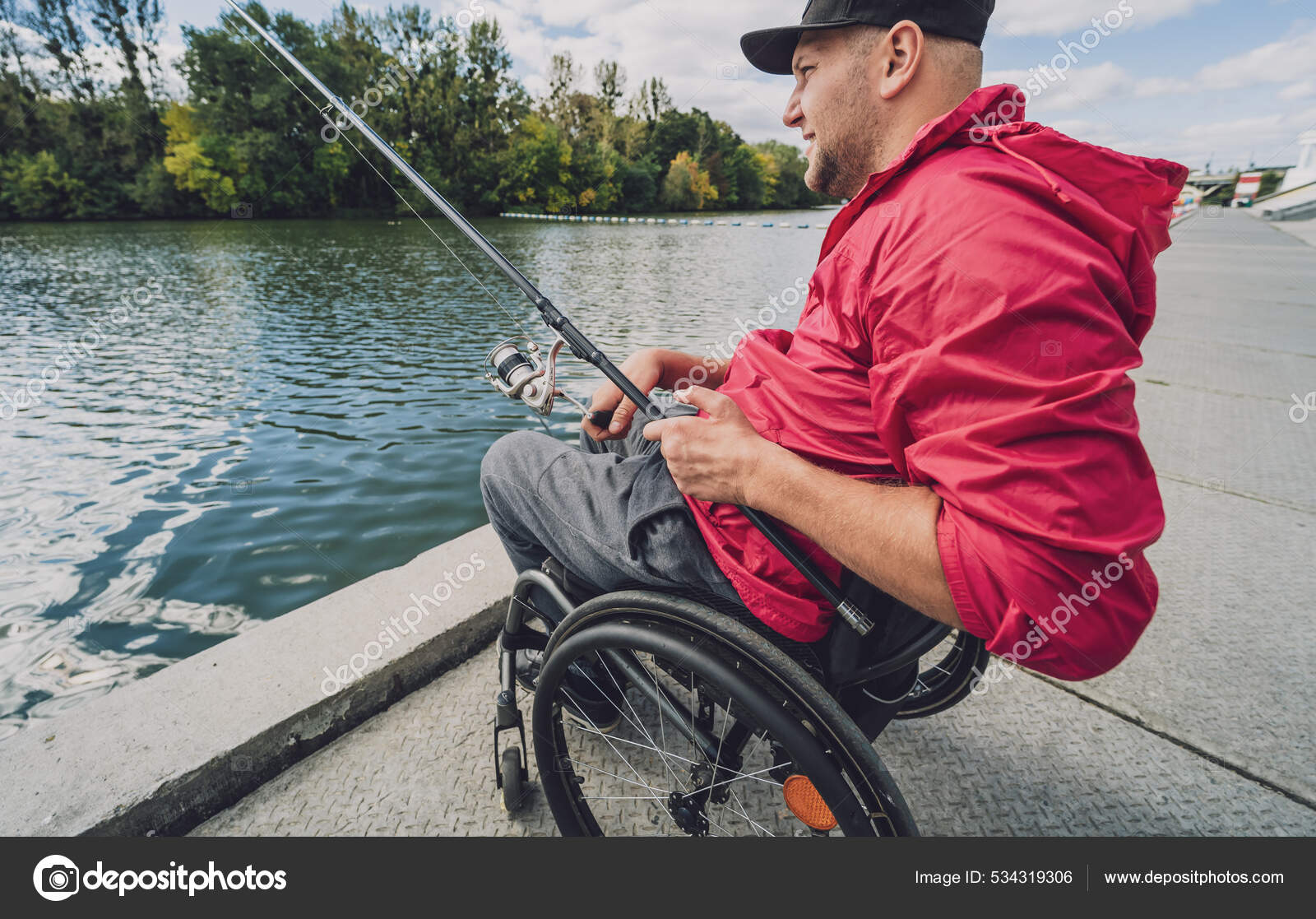 Person with a physical disability in a wheelchair fishing from fishing  pier. — Stock Photo © Romaset #534319306