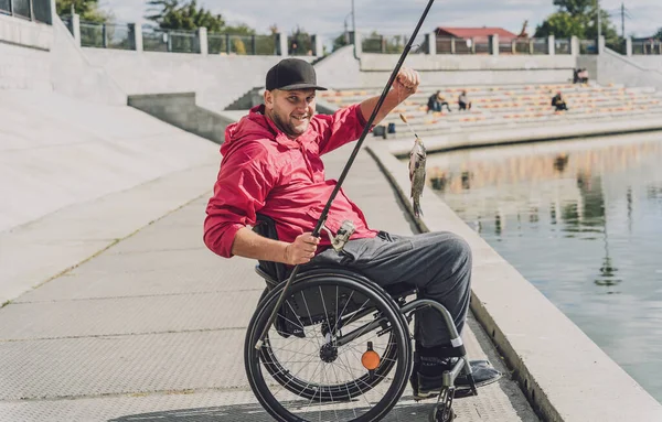 Osoba s tělesným postižením, která používá bezbariérový rybolov z rybářského mola. — Stock fotografie