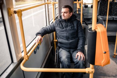 Toplu taşıma araçlarında fiziksel engelli ve erişilebilir rampası olan biri..
