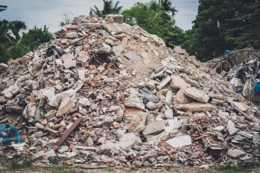 Waste plastic bottles and other types of waste at the ground