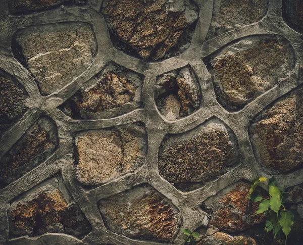 Background and texture of old stoned wall — Stockfoto