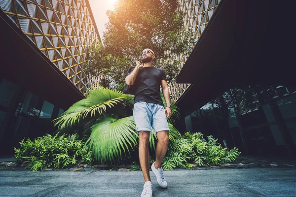 Ormanda yeşil yaprakları olan genç bir adamın portresi.