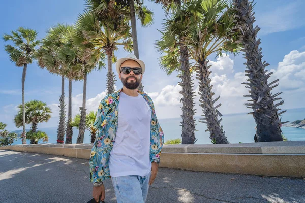 Jovem viajante homem em férias de verão com belas palmas e paisagens marinhas no fundo — Fotografia de Stock