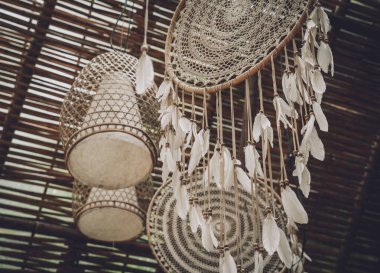 Tüyleri iplik ve boncukları sallanan bir düş kapanı..