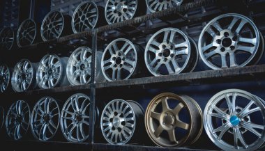 Bir dükkanda sıra sıra metal araba diskleri.