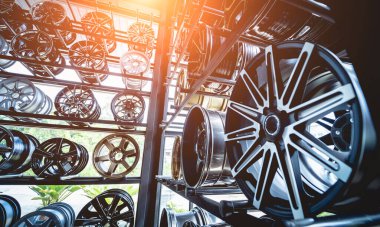 Bir dükkanda sıra sıra metal araba diskleri.