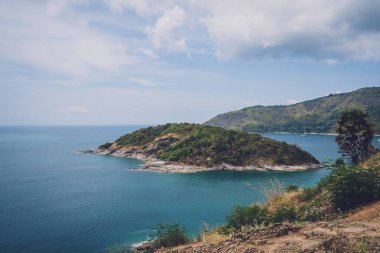 Okyanusta palmiye ağaçları olan güzel dağlar.