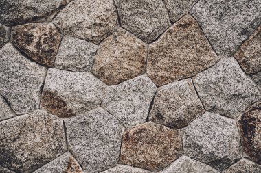 Eski taşlaşmış duvarın arka planı ve dokusu.