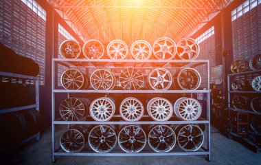 Bir dükkanda sıra sıra metal araba diskleri.