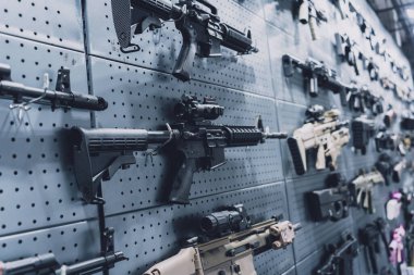 Collection of rifles and carbines on the wall.