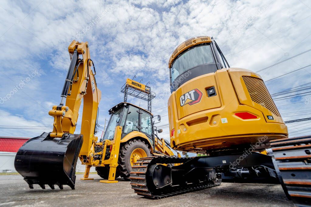 PHUKET, TAHAILAND - JUNE 05, 2022: Caterpillar heavy duty equipment vehicle on display area of dealership.