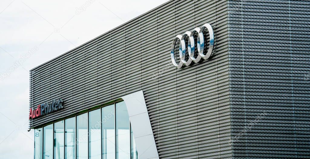 PHUKET, TAHAILAND - JUNE 05, 2022: Showroom of dealership Audi. Signboard with logo of Audi against blue sky.