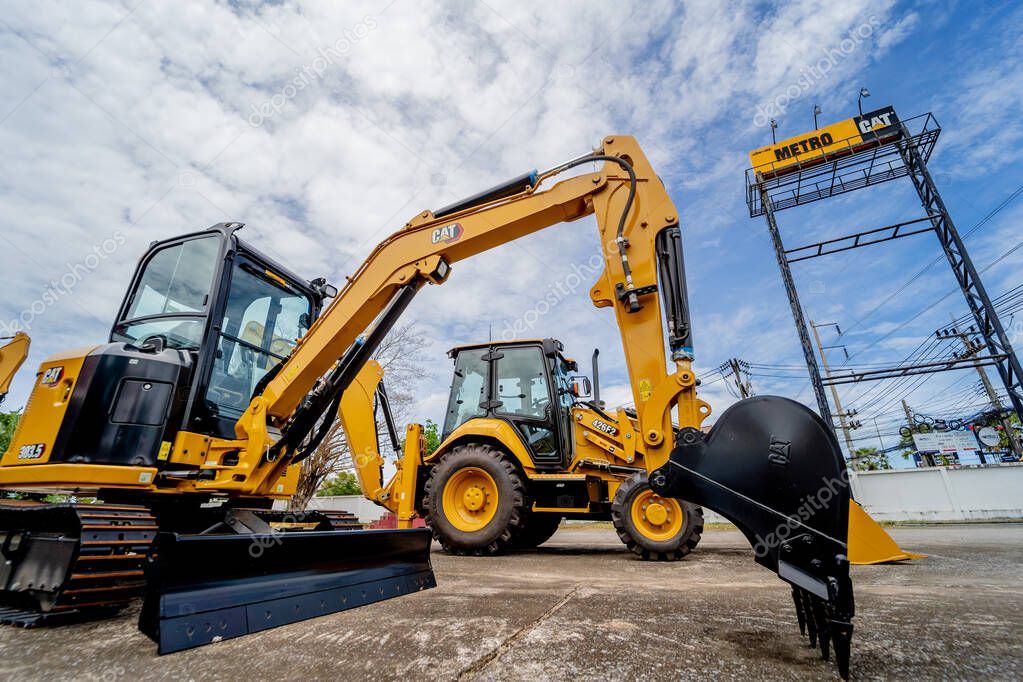 PHUKET, TAHAILAND - JUNE 05, 2022: Caterpillar heavy duty equipment vehicle on display area of dealership.